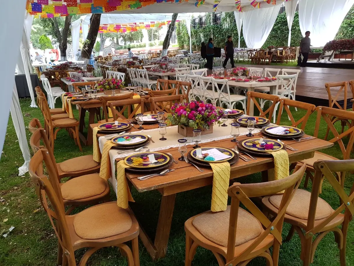 Fiesta mexicana con papel picado y mesas de madera